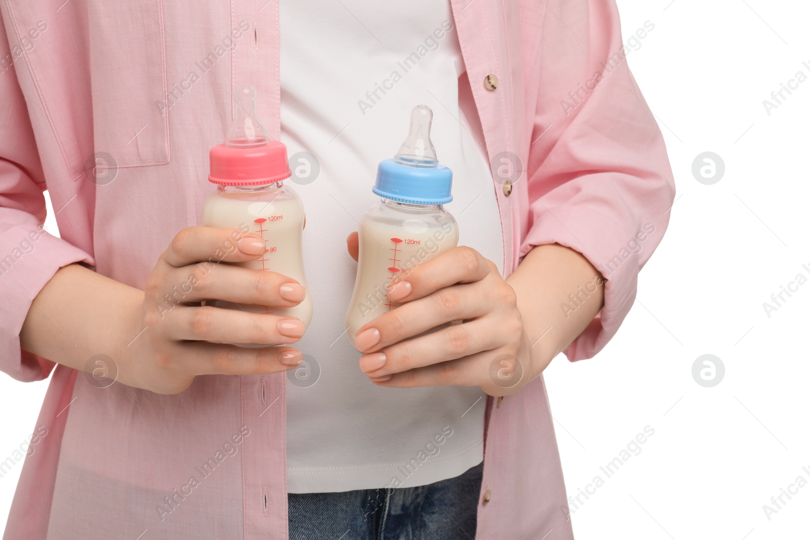 Photo of Expecting twins. Pregnant woman holding two bottles with milk on white background, closeup