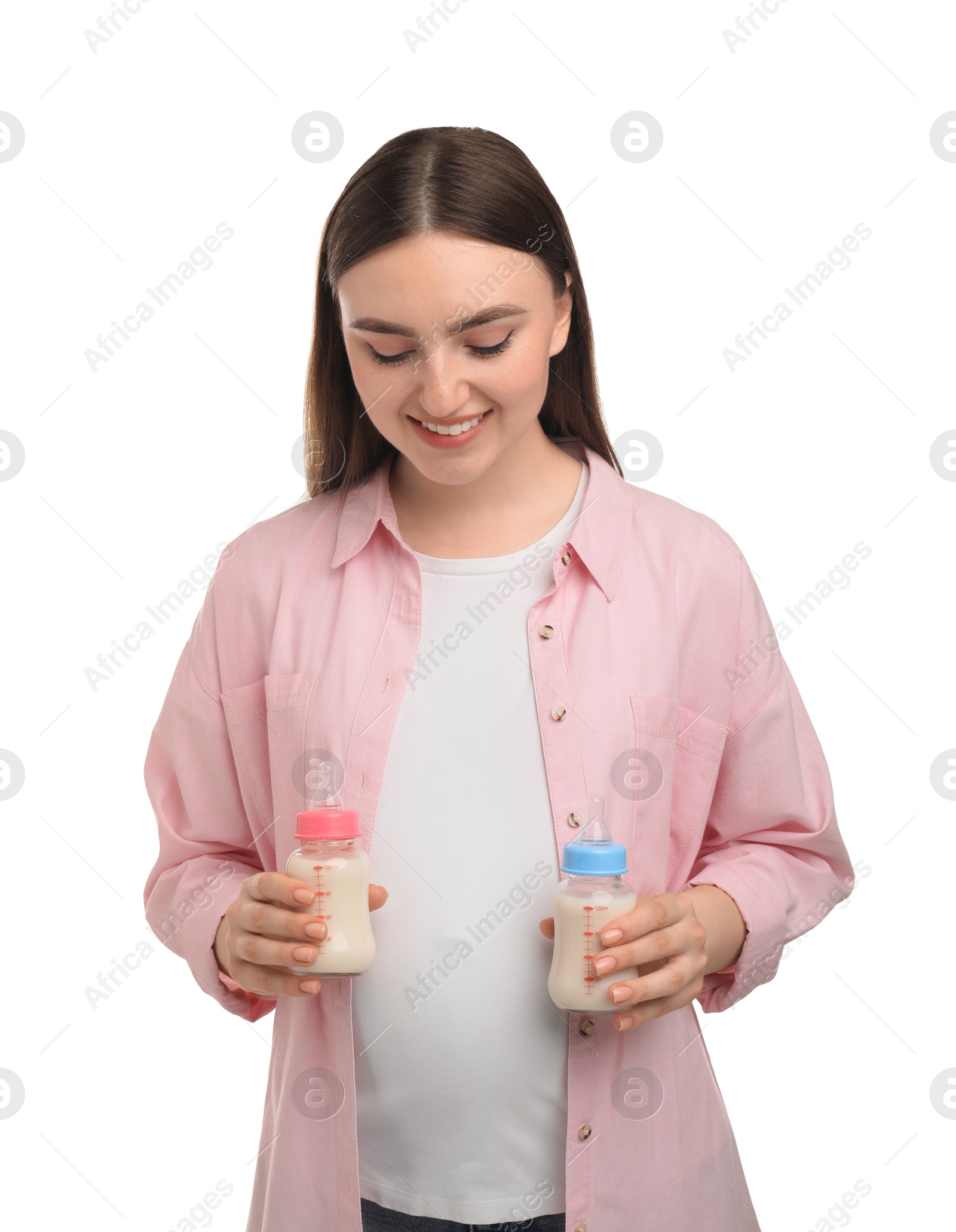 Photo of Expecting twins. Pregnant woman holding two bottles with milk on white background