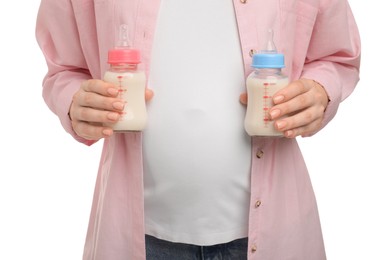 Photo of Expecting twins. Pregnant woman holding two bottles with milk on white background, closeup