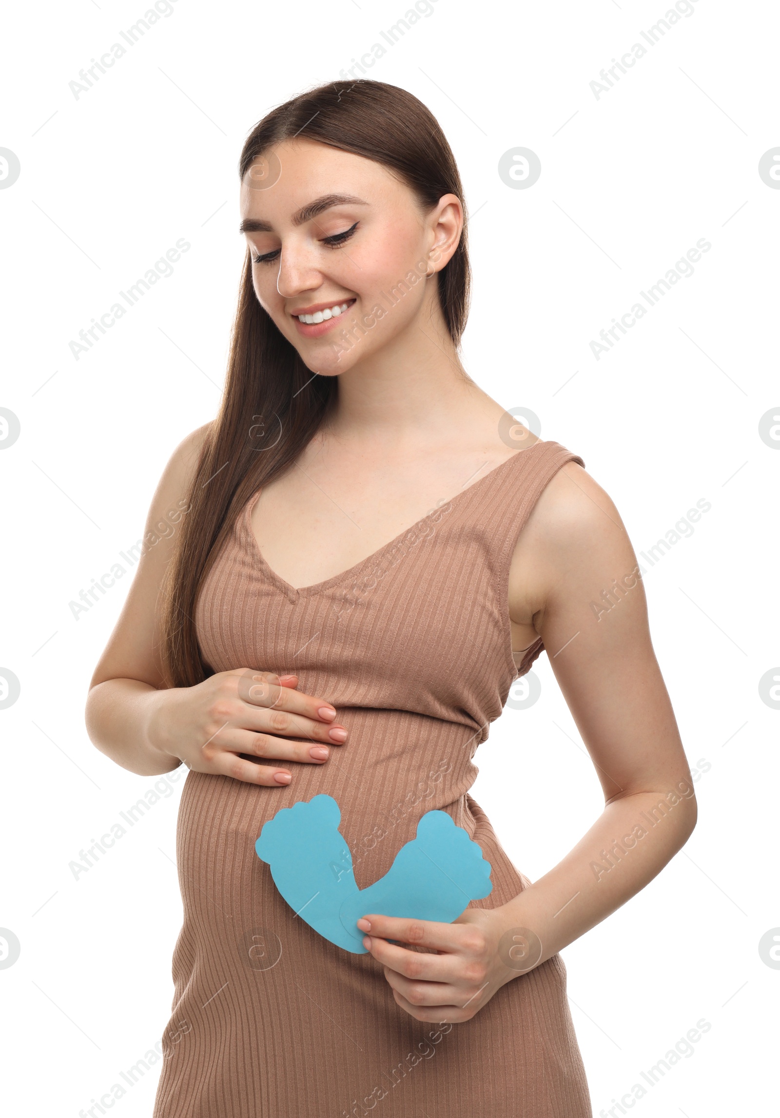 Photo of Expecting twins. Pregnant woman holding two paper cutouts of feet on white background