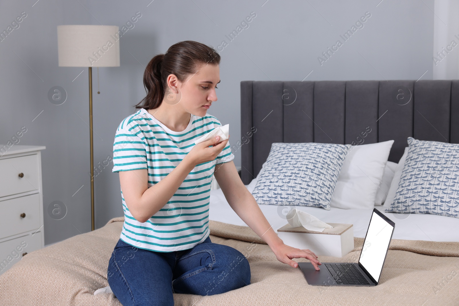 Photo of Sick woman having online consultation with doctor via laptop at home