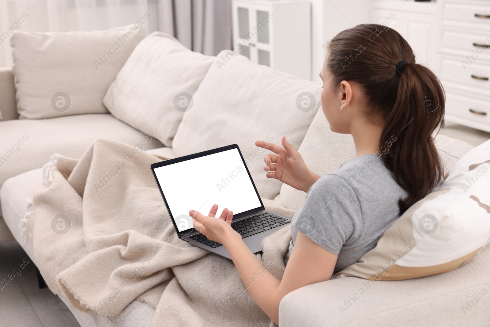 Photo of Sick woman having online consultation with doctor via laptop at home