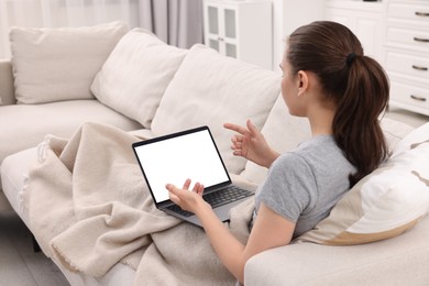 Sick woman having online consultation with doctor via laptop at home