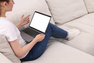 Photo of Sick woman having online consultation with doctor via laptop at home