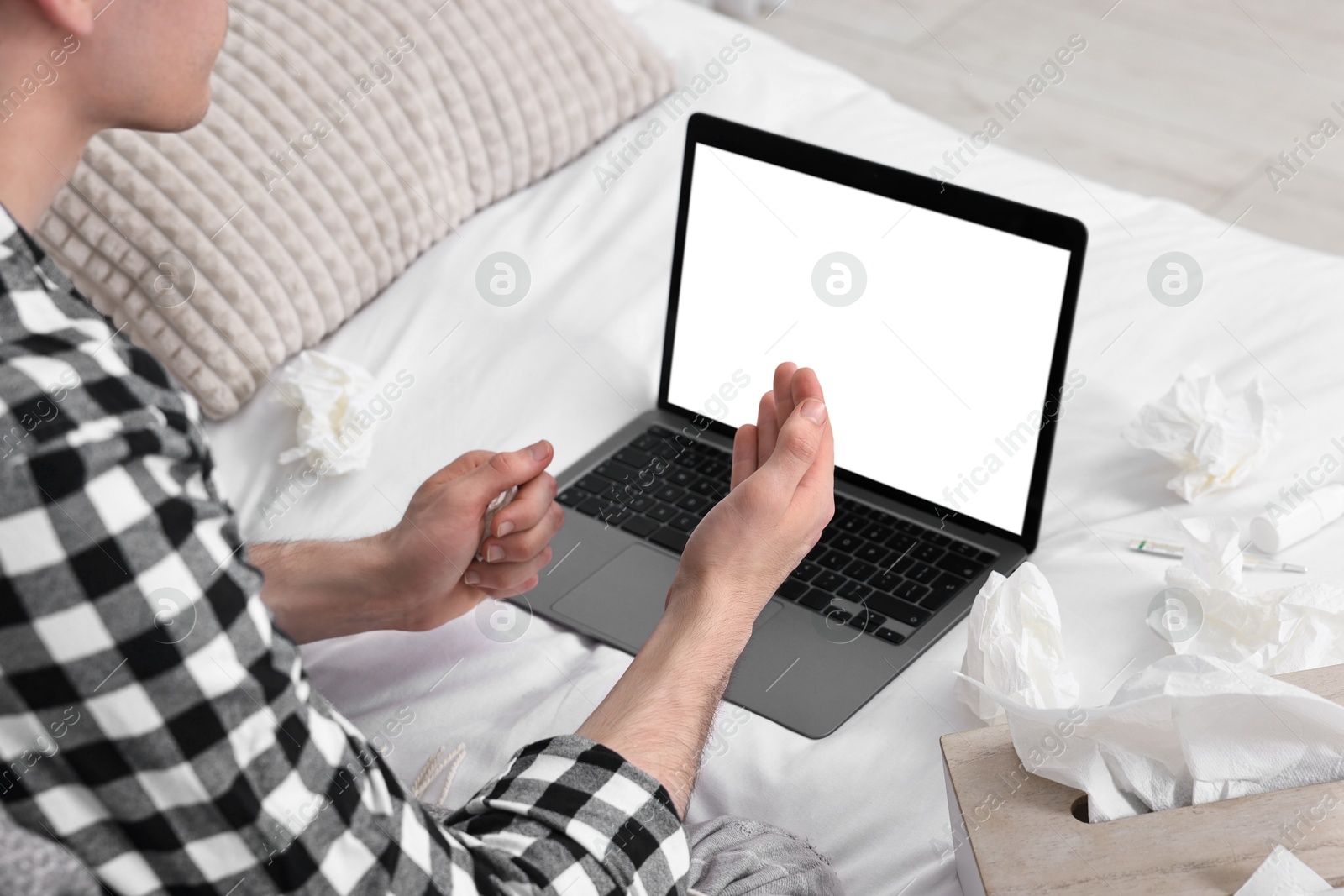 Photo of Sick man having online consultation with doctor via laptop at home, closeup