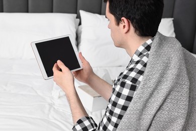 Photo of Sick man having online consultation with doctor via tablet at home