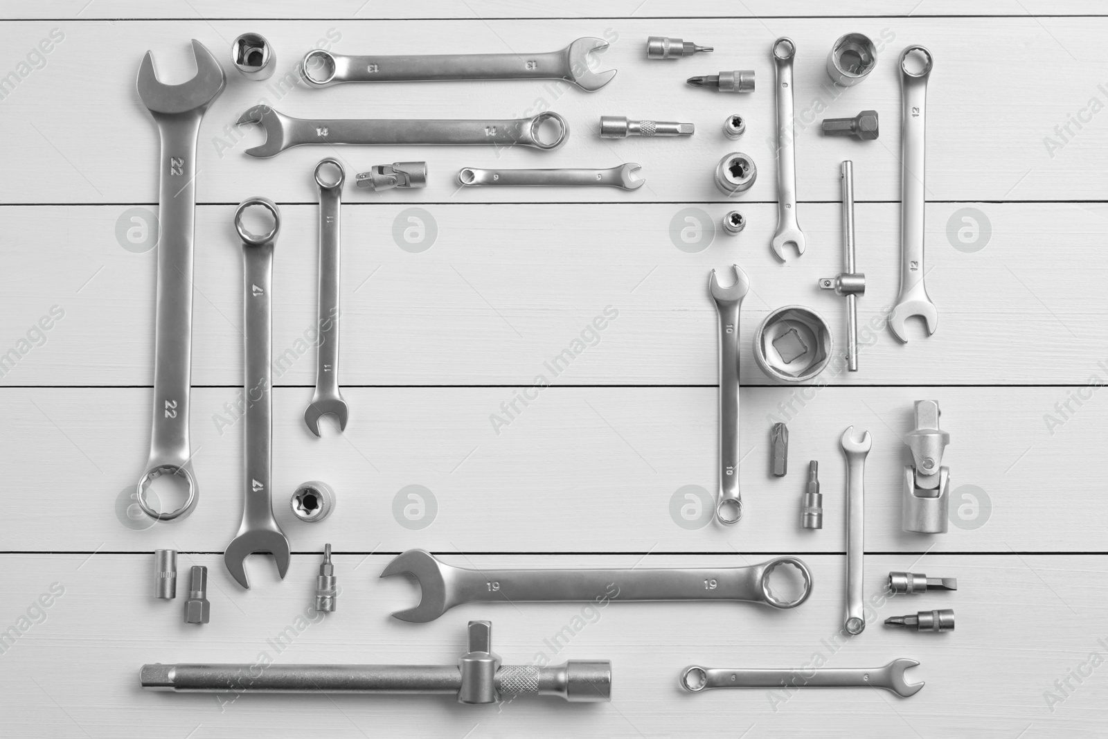 Photo of Auto mechanic's tools on white wooden table, flat lay. Space for text