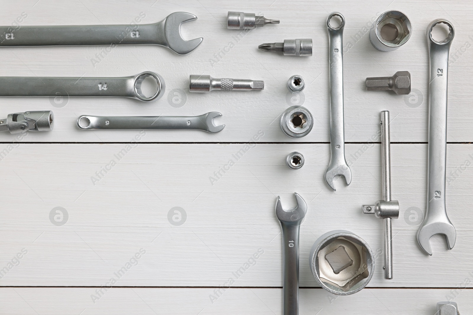 Photo of Auto mechanic's tools on white wooden table, flat lay. Space for text