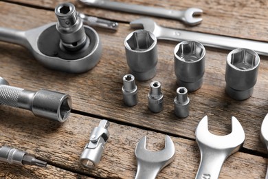 Different auto mechanic's tools on wooden table