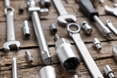 Different auto mechanic's tools on wooden table, closeup