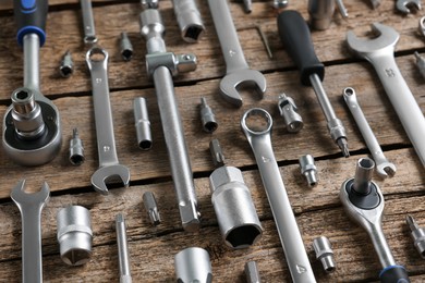 Photo of Different auto mechanic's tools on wooden table