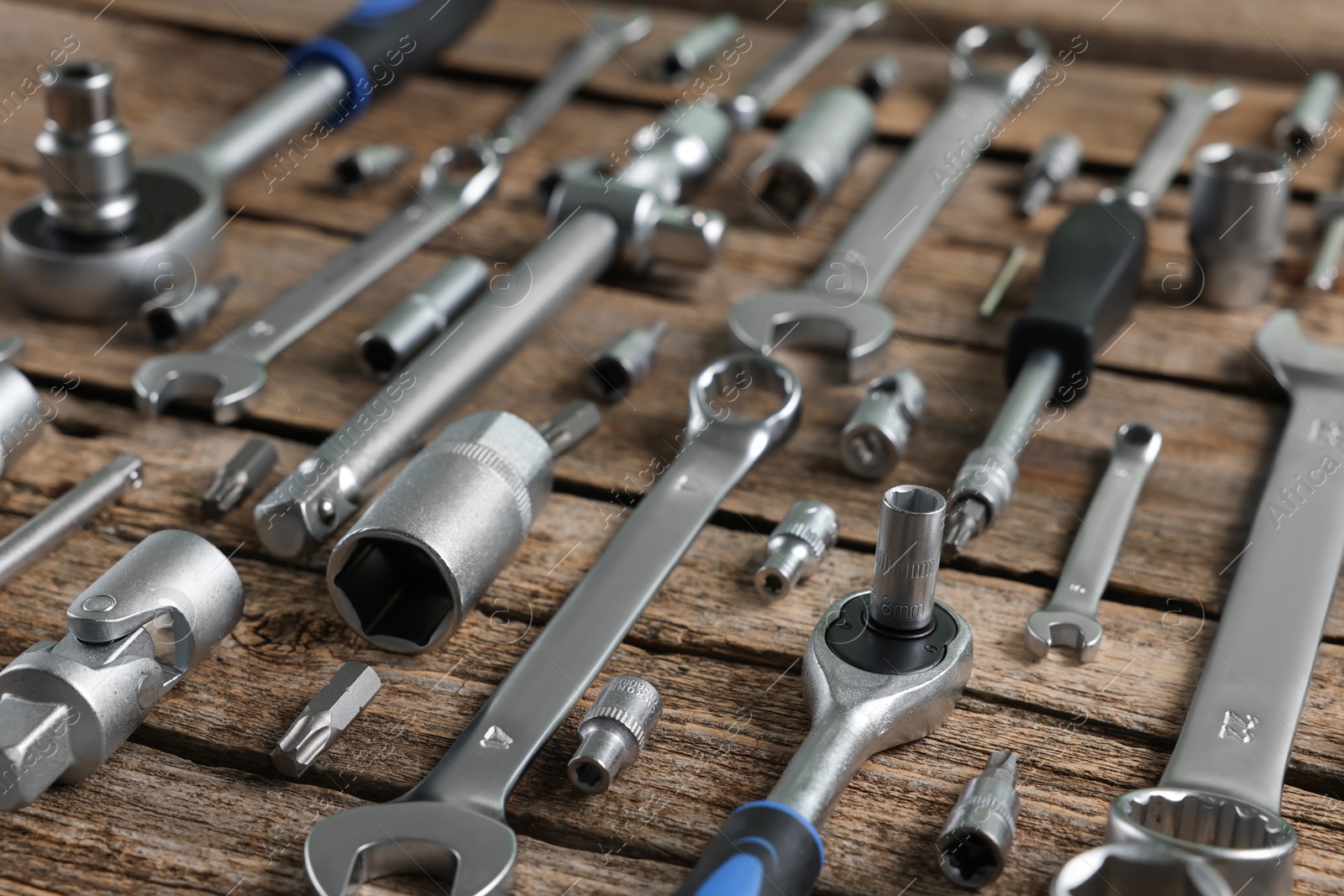 Photo of Different auto mechanic's tools on wooden table