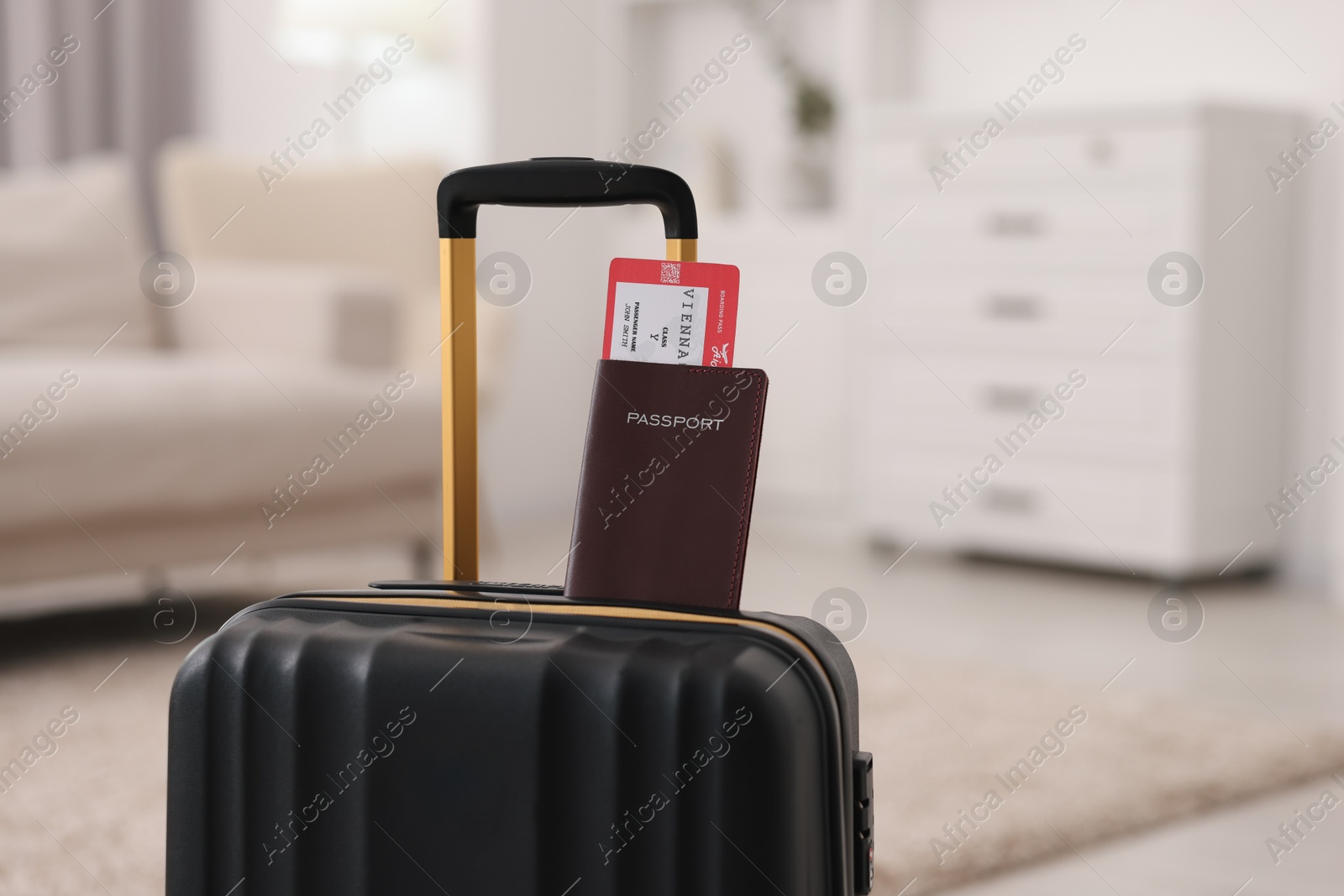 Photo of Black suitcase, passport and ticket at home, space for text