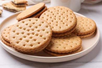 Tasty sandwich cookies on light table, closeup