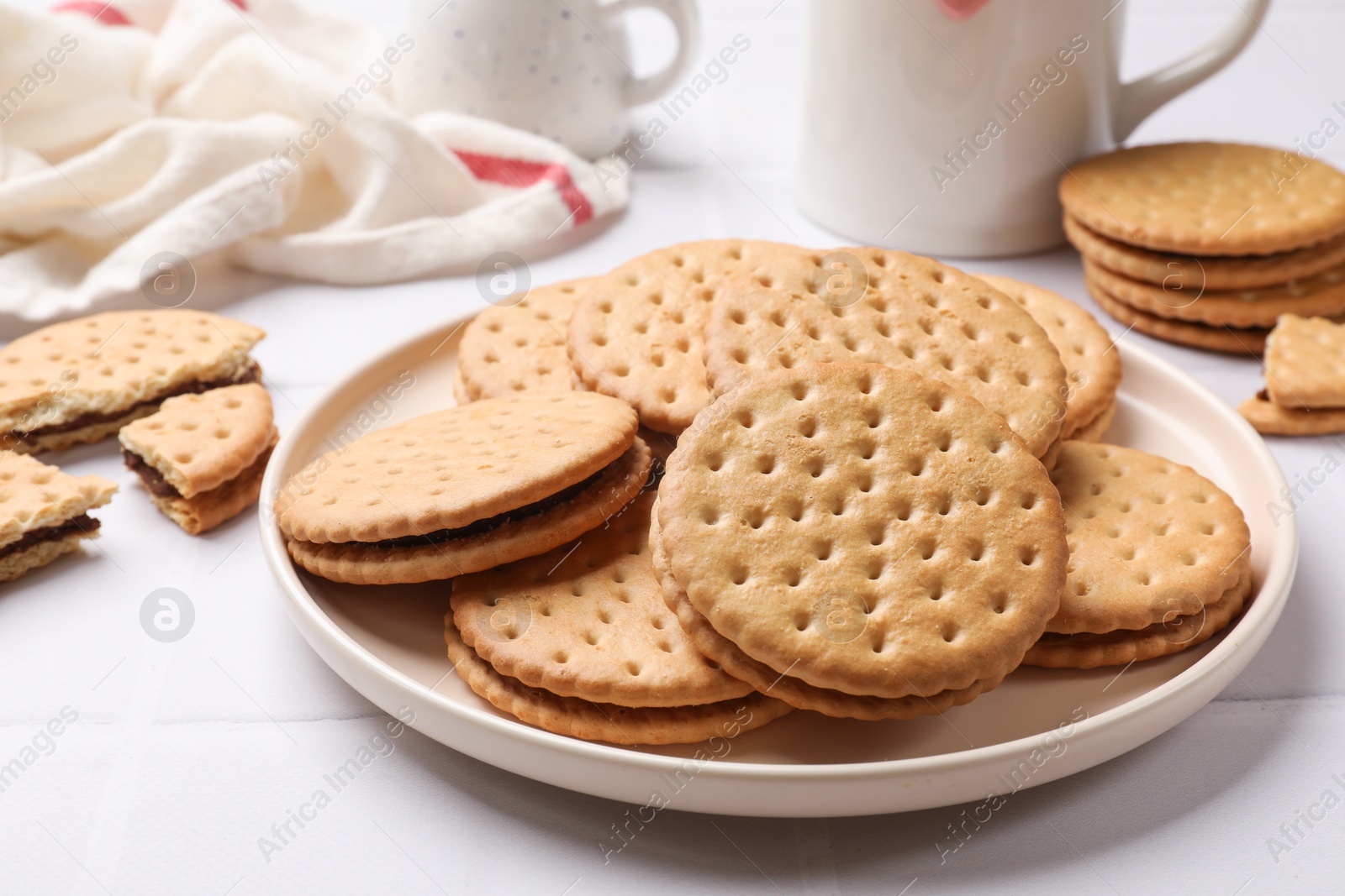 Photo of Tasty sandwich cookies on white table, closeup