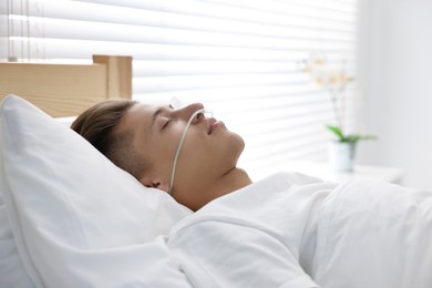 Photo of Coma patient. Young man sleeping in hospital bed