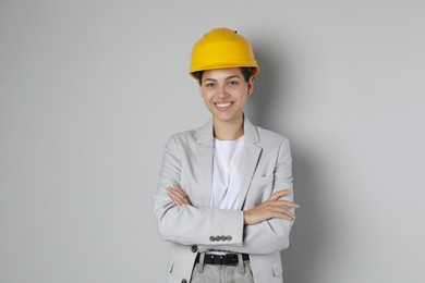 Photo of Engineer in hard hat on grey background