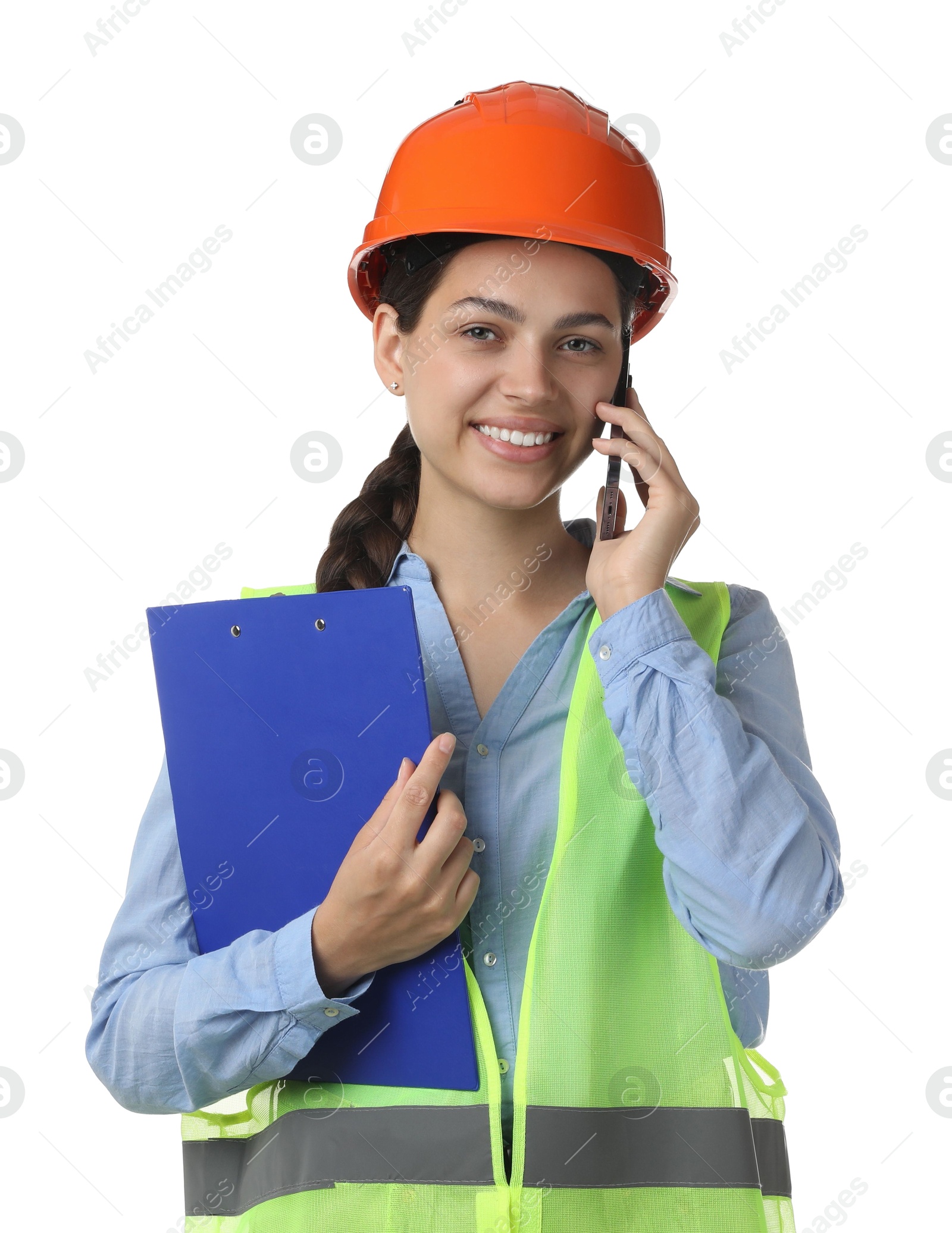 Photo of Engineer in hard hat with clipboard talking on smartphone against white background