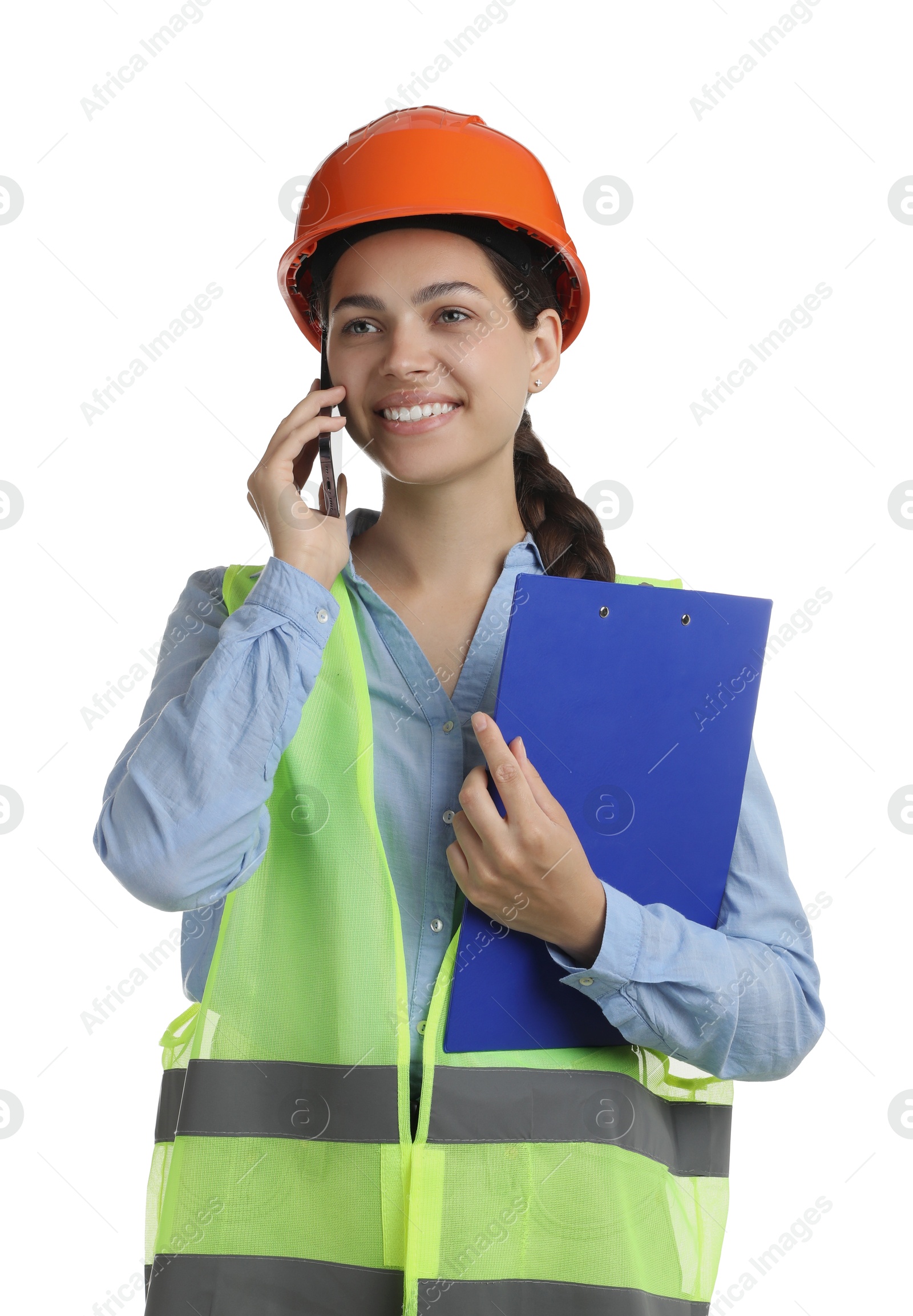 Photo of Engineer in hard hat with clipboard talking on smartphone against white background