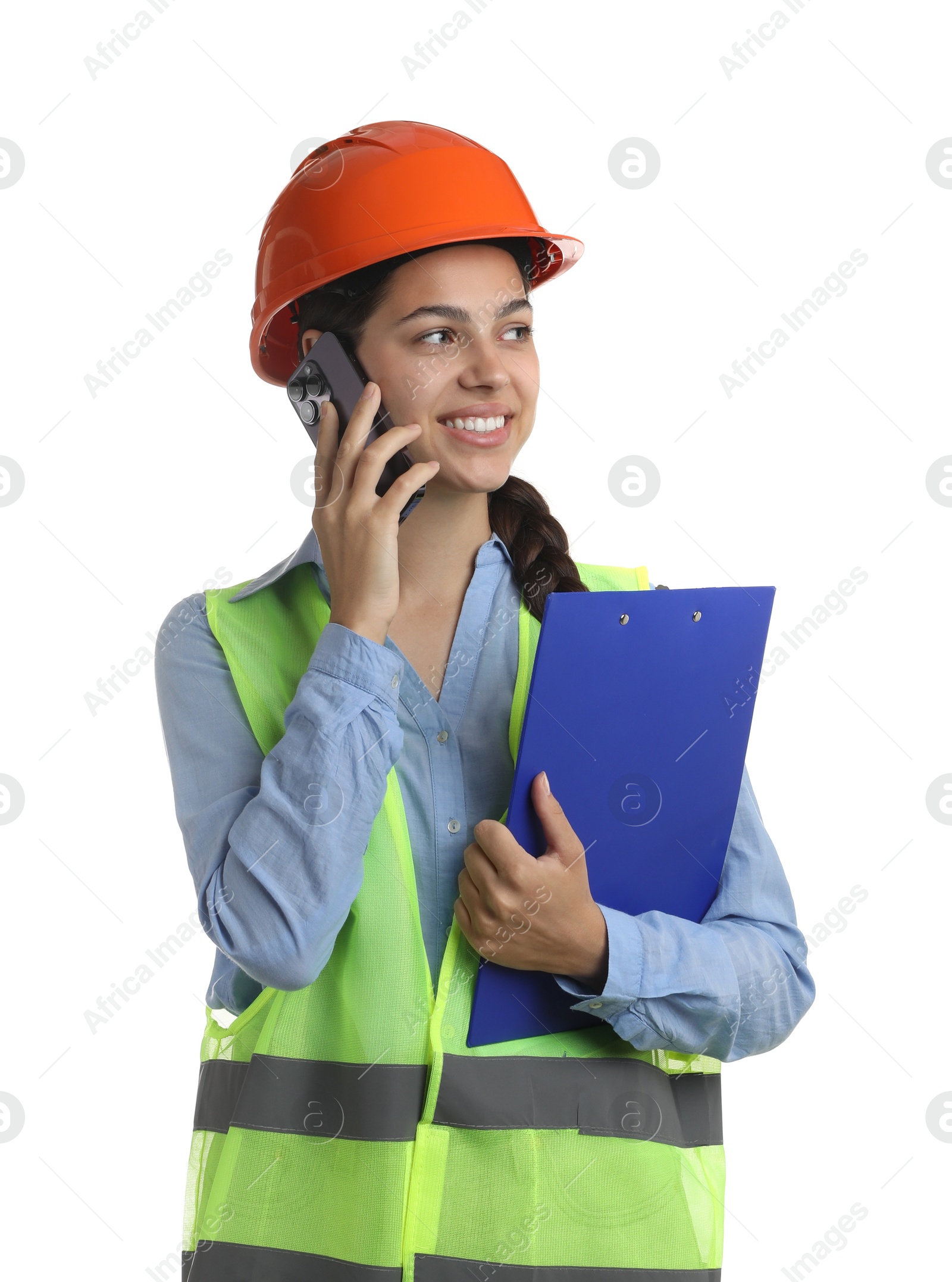 Photo of Engineer in hard hat with clipboard talking on smartphone against white background