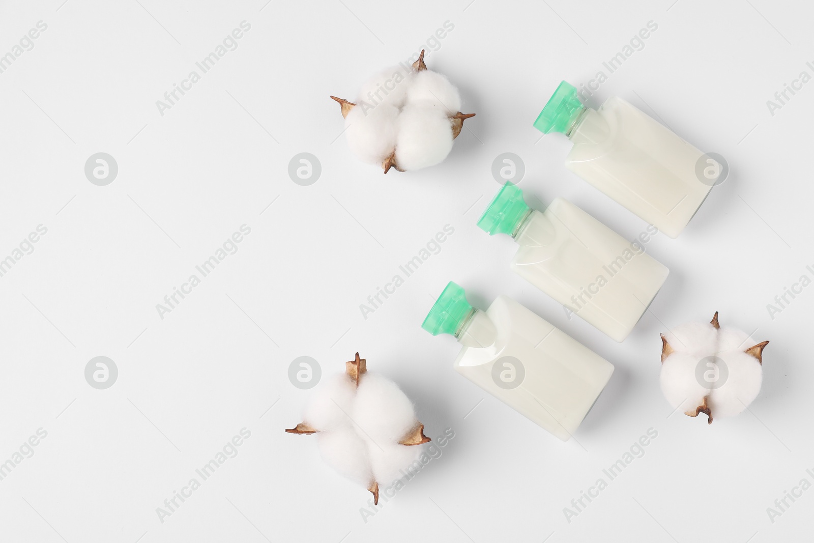 Photo of Cosmetic products and cotton flowers on white background, flat lay. Space for text