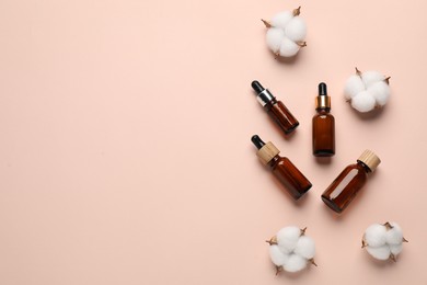 Photo of Different cosmetic products and cotton flowers on beige background, flat lay. Space for text