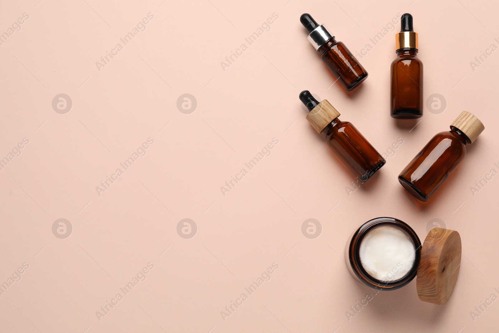 Photo of Different cosmetic products and cotton flowers on beige background, flat lay. Space for text