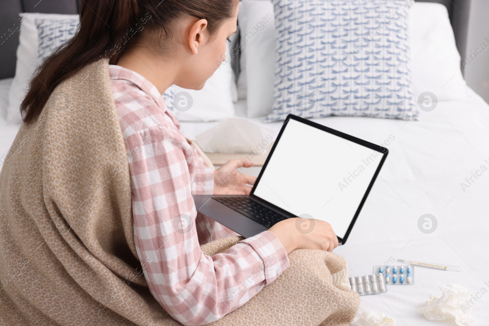 Photo of Sick woman having online consultation with doctor via laptop at home