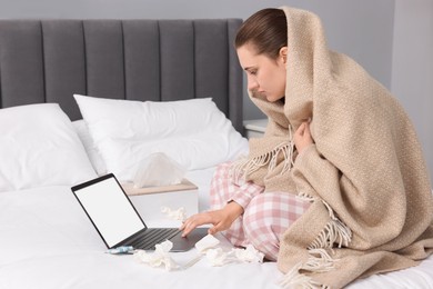 Photo of Sick woman having online consultation with doctor via laptop at home