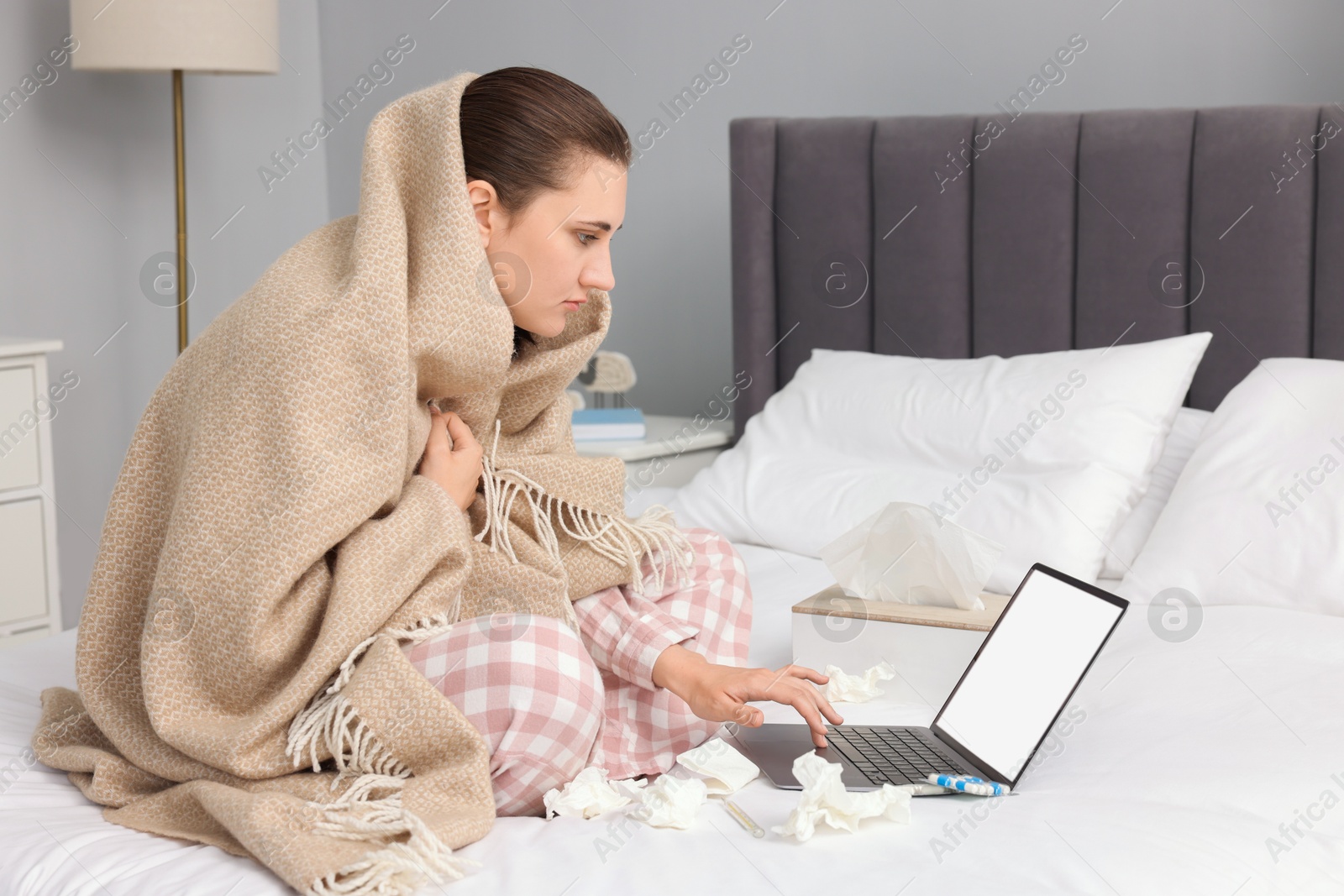 Photo of Sick woman having online consultation with doctor via laptop at home