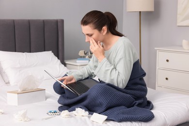 Sick woman having online consultation with doctor via laptop at home