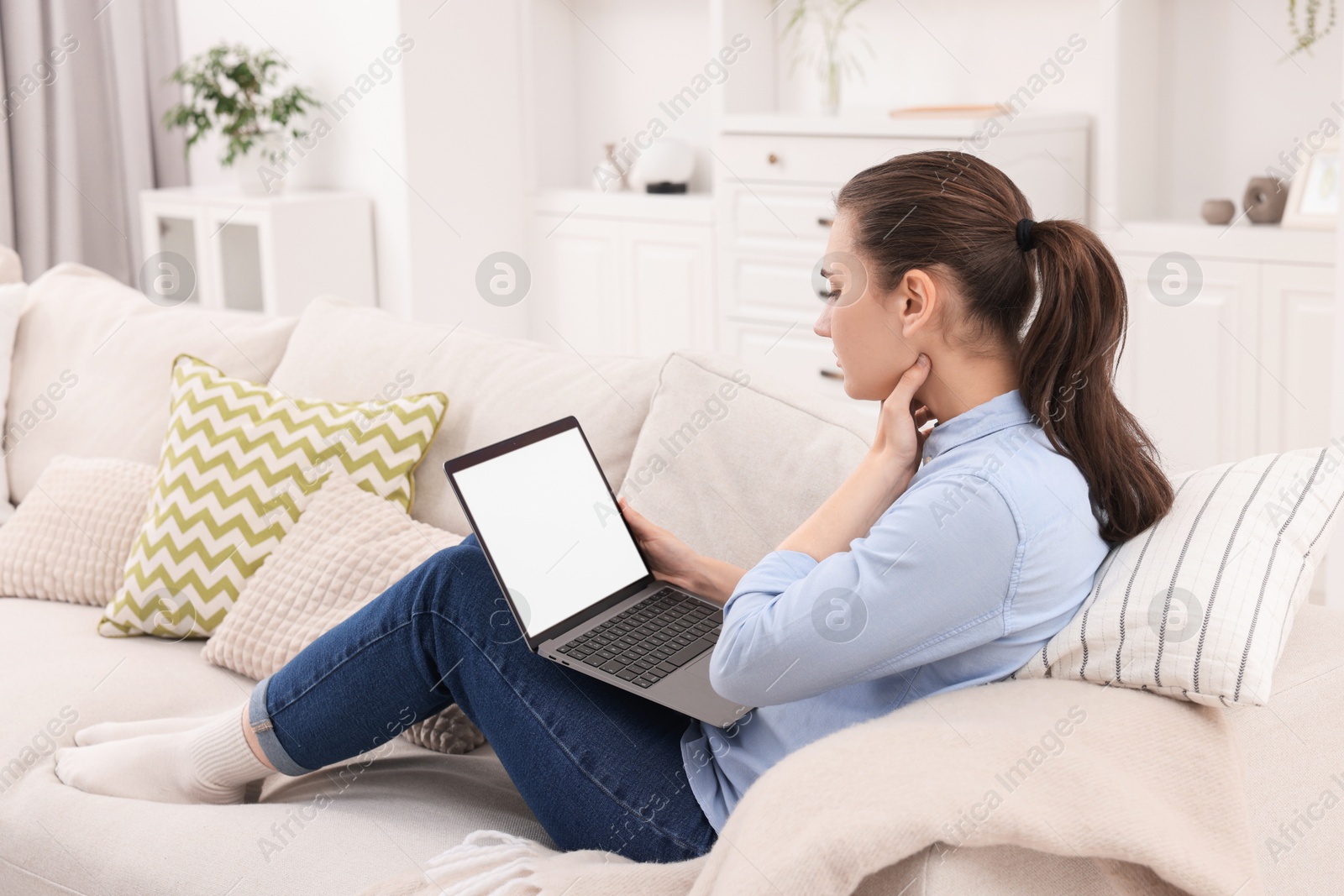 Photo of Sick woman having online consultation with doctor via laptop at home