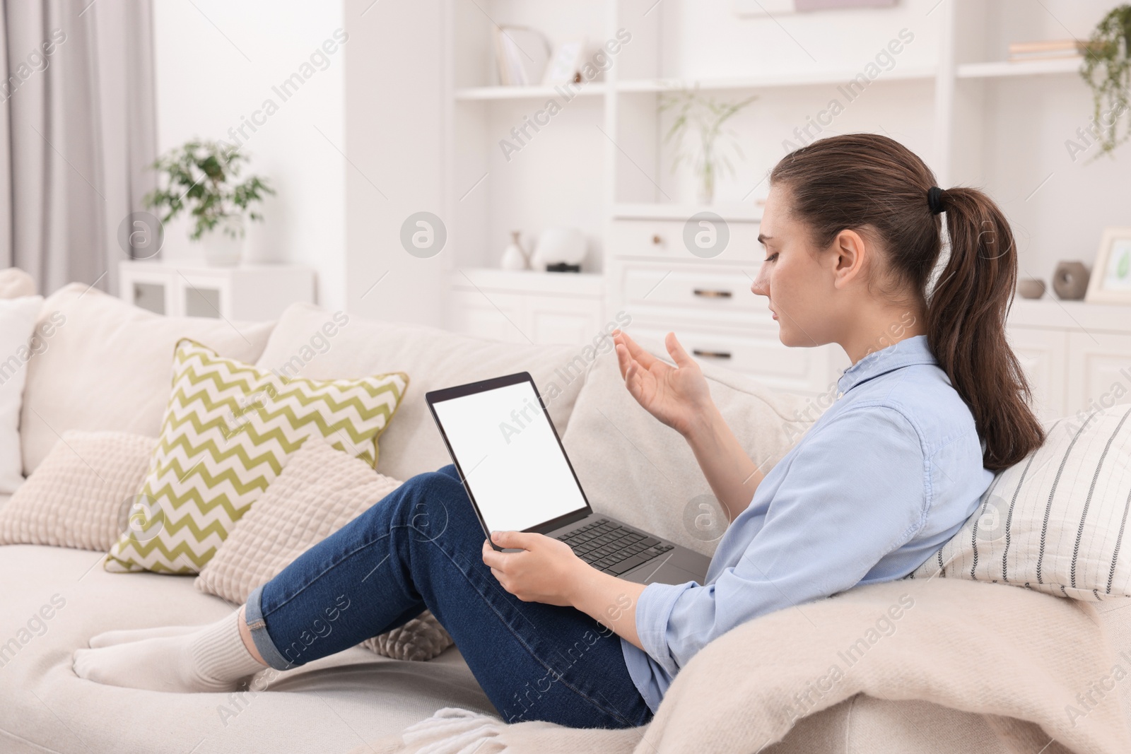 Photo of Sick woman having online consultation with doctor via laptop at home