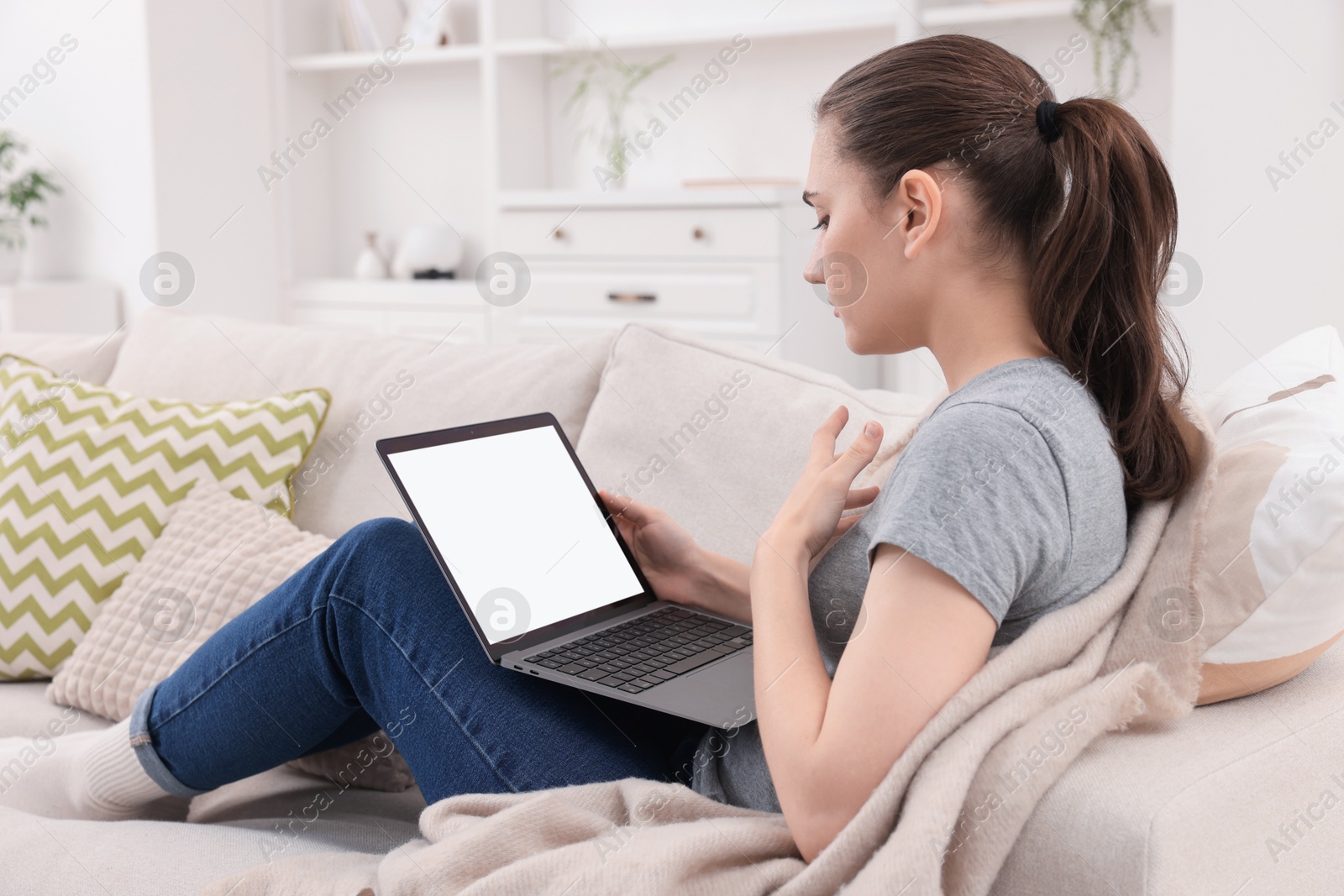 Photo of Sick woman having online consultation with doctor via laptop at home