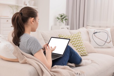 Sick woman having online consultation with doctor via laptop at home