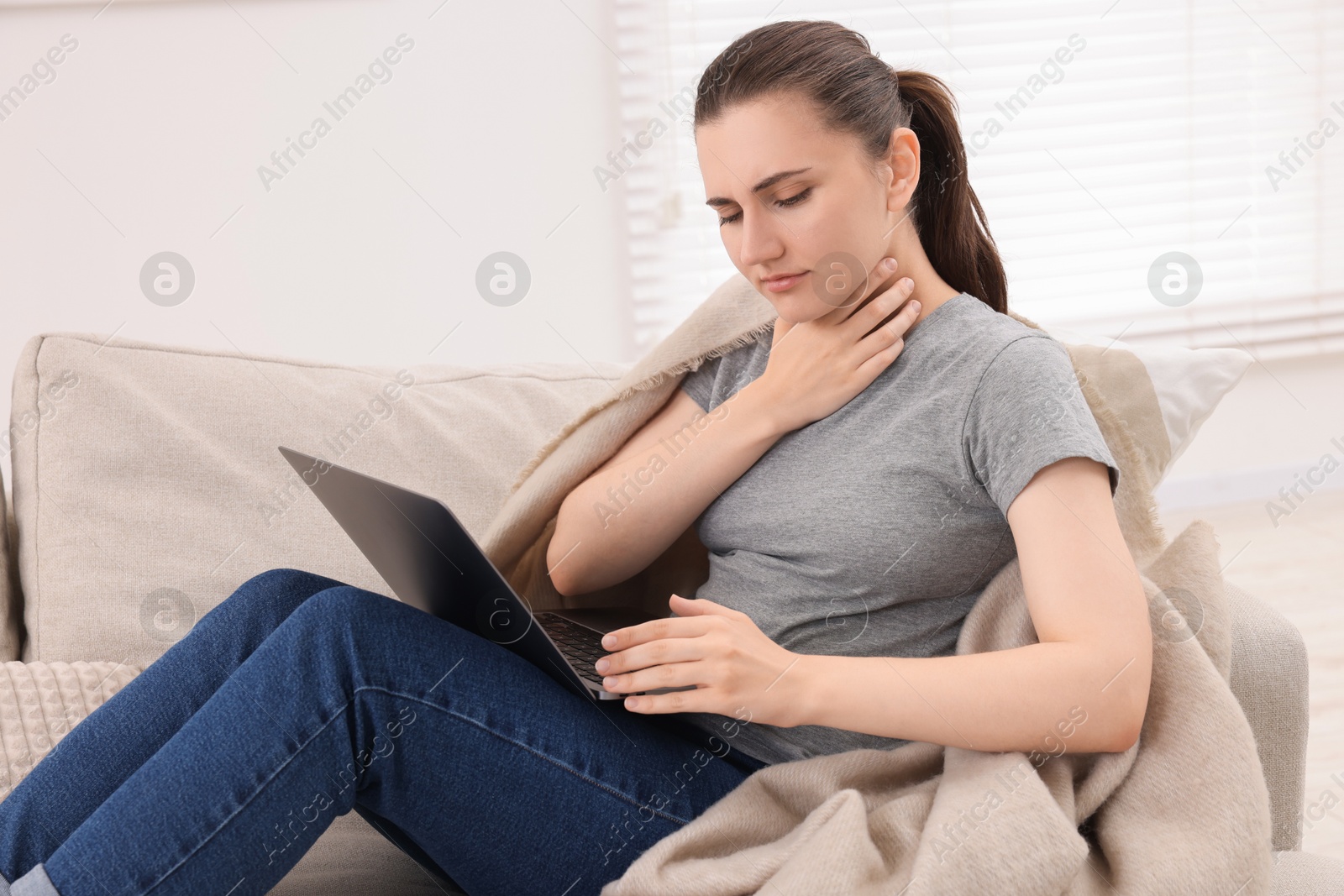 Photo of Sick woman having online consultation with doctor via laptop at home