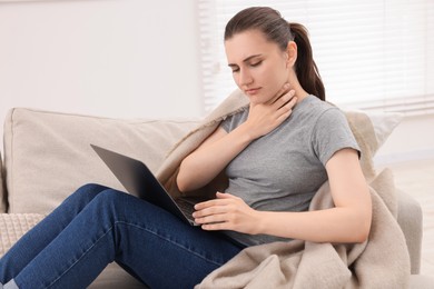 Photo of Sick woman having online consultation with doctor via laptop at home