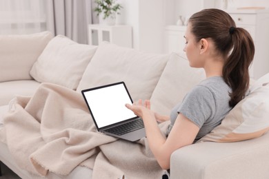 Photo of Sick woman having online consultation with doctor via laptop at home