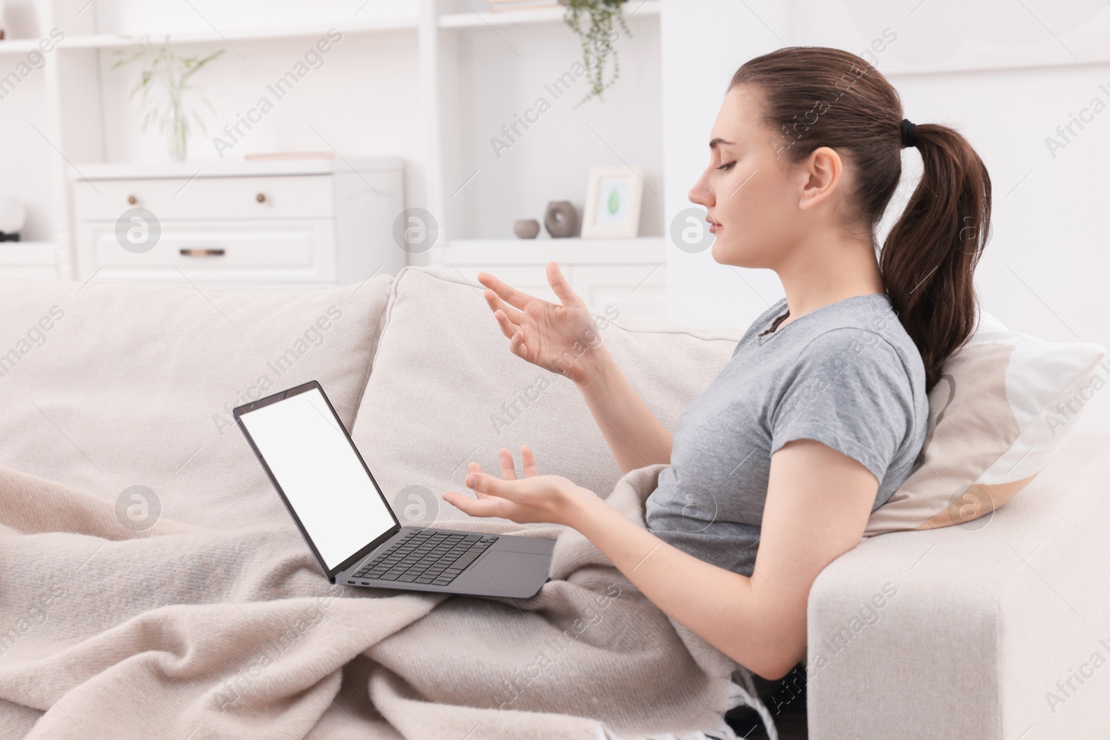 Photo of Sick woman having online consultation with doctor via laptop at home