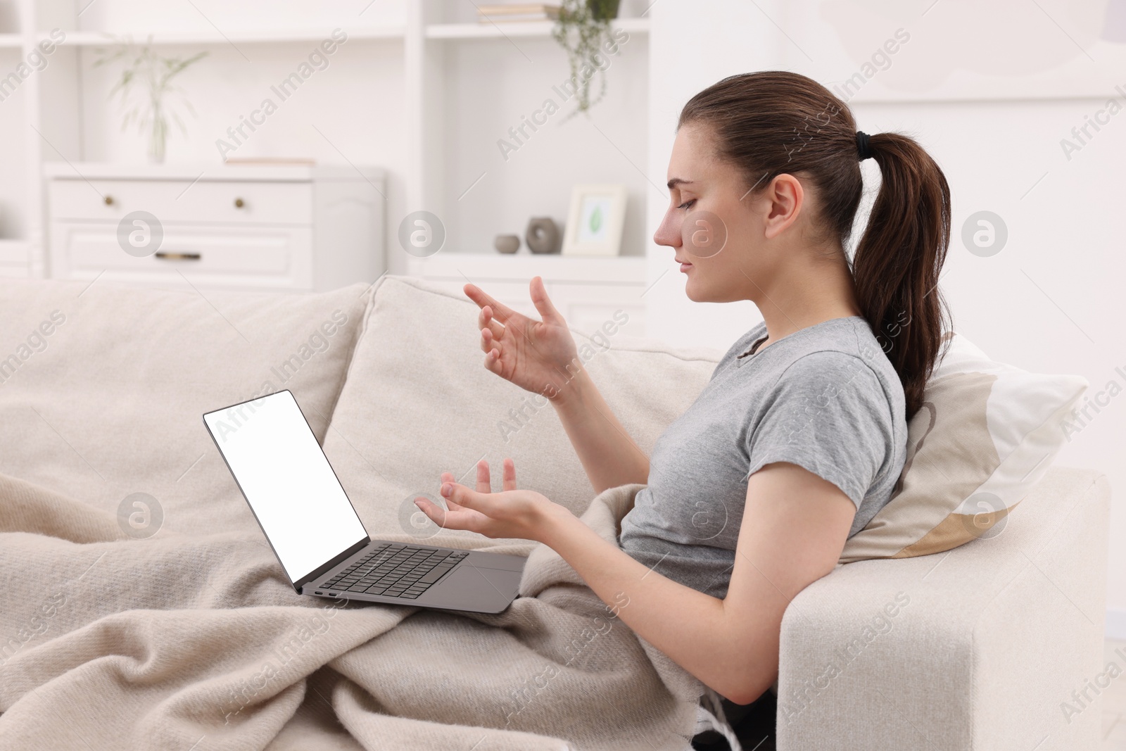 Photo of Sick woman having online consultation with doctor via laptop at home