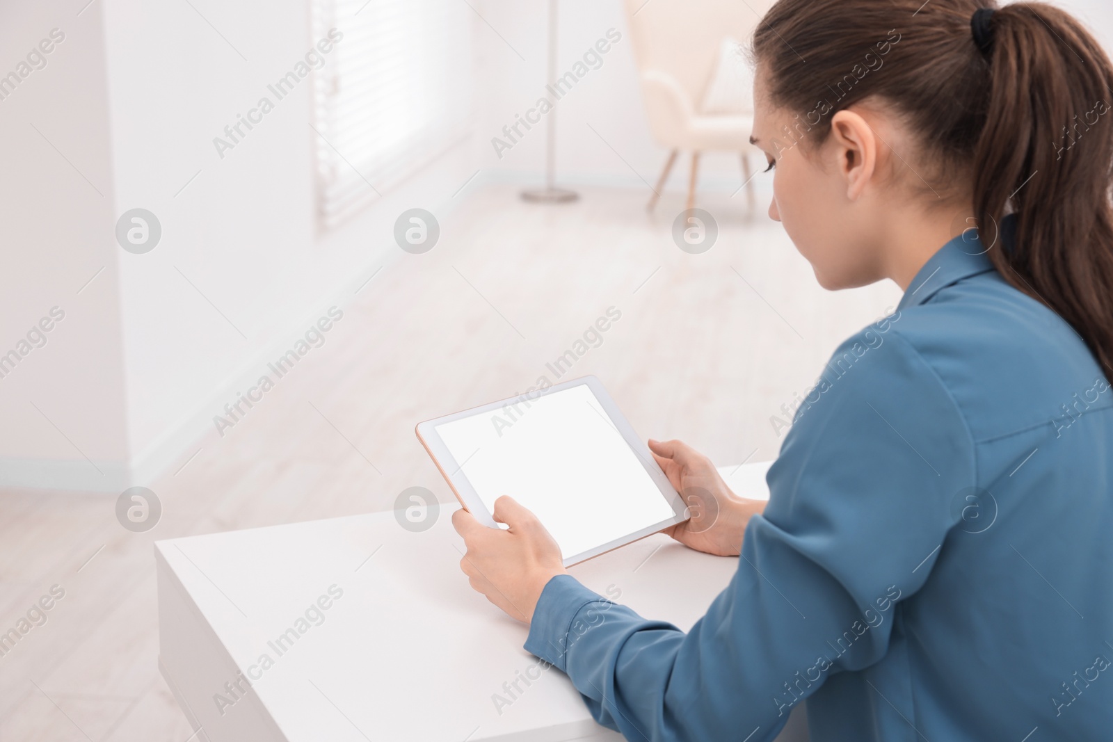 Photo of Sick woman having online consultation with doctor via tablet at white table indoors