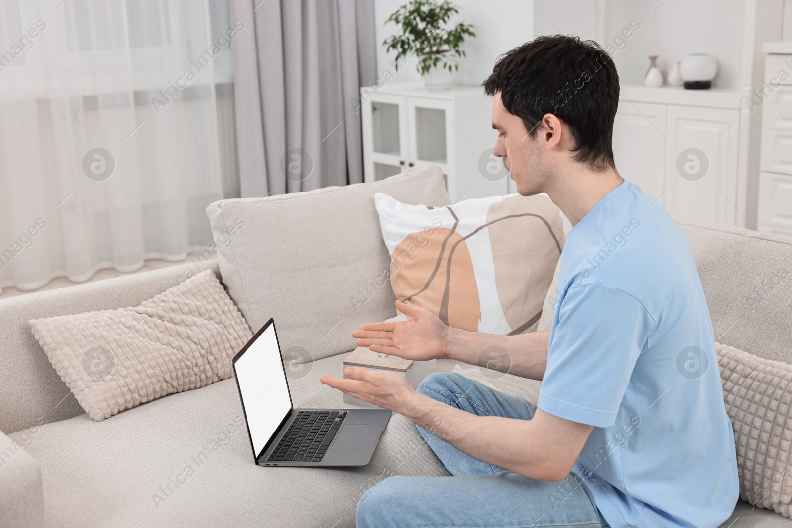 Photo of Sick man having online consultation with doctor via laptop at home