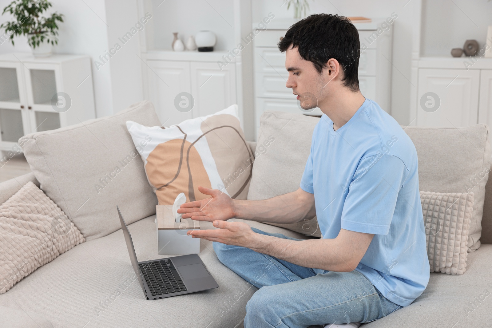 Photo of Sick man having online consultation with doctor via laptop at home