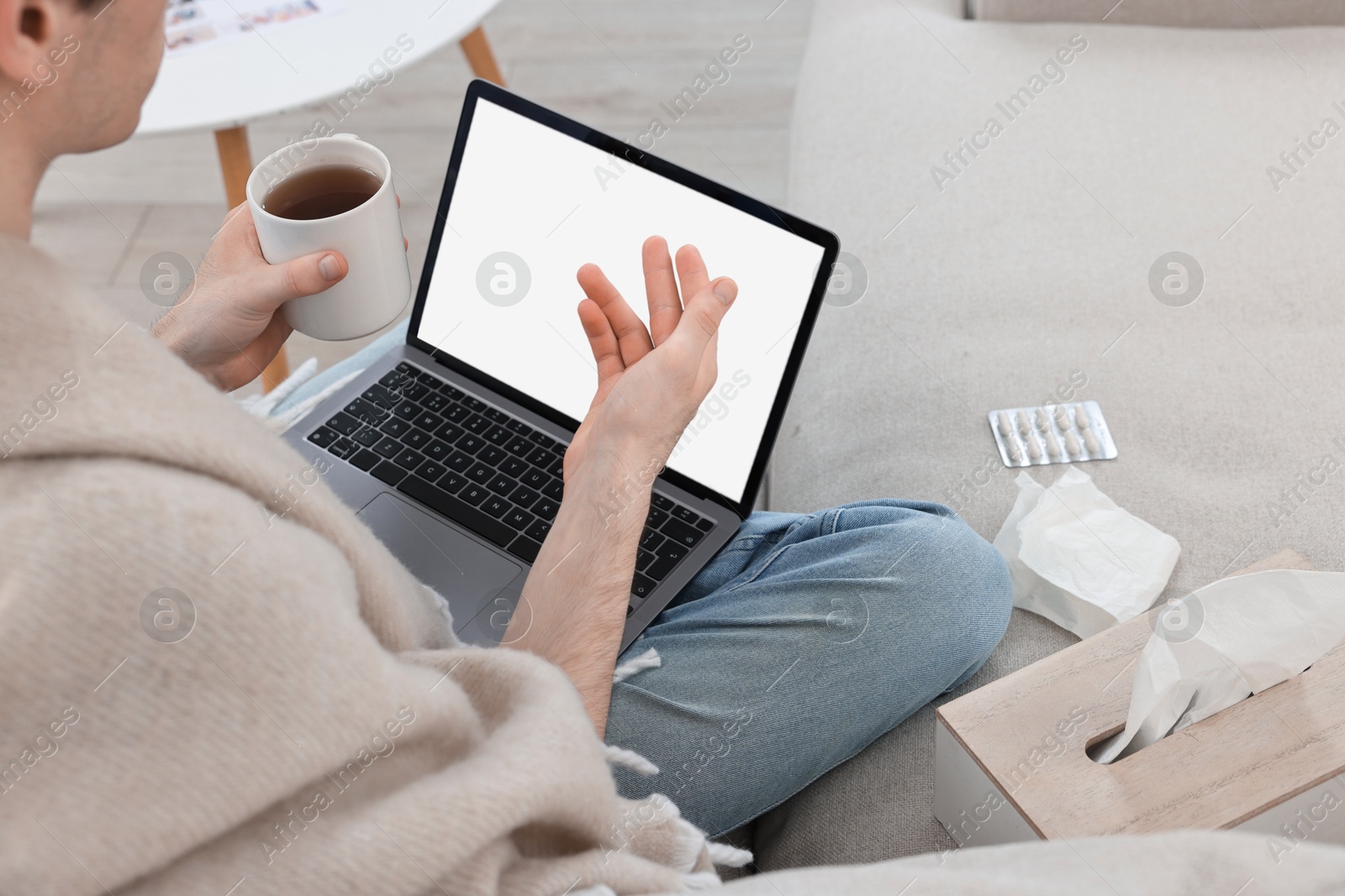 Photo of Sick man having online consultation with doctor via laptop at home, closeup