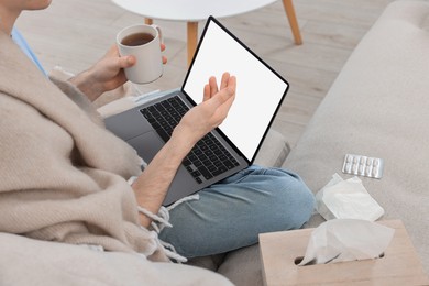 Sick man having online consultation with doctor via laptop at home, closeup