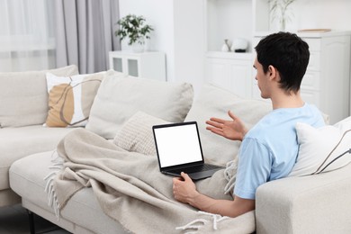 Photo of Sick man having online consultation with doctor via laptop at home