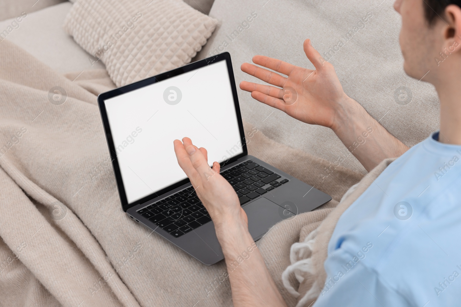 Photo of Sick man having online consultation with doctor via laptop at home, closeup