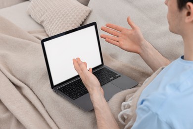 Photo of Sick man having online consultation with doctor via laptop at home, closeup