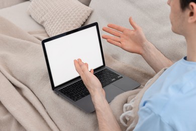 Sick man having online consultation with doctor via laptop at home, closeup