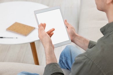 Sick man having online consultation with doctor via tablet at home, closeup